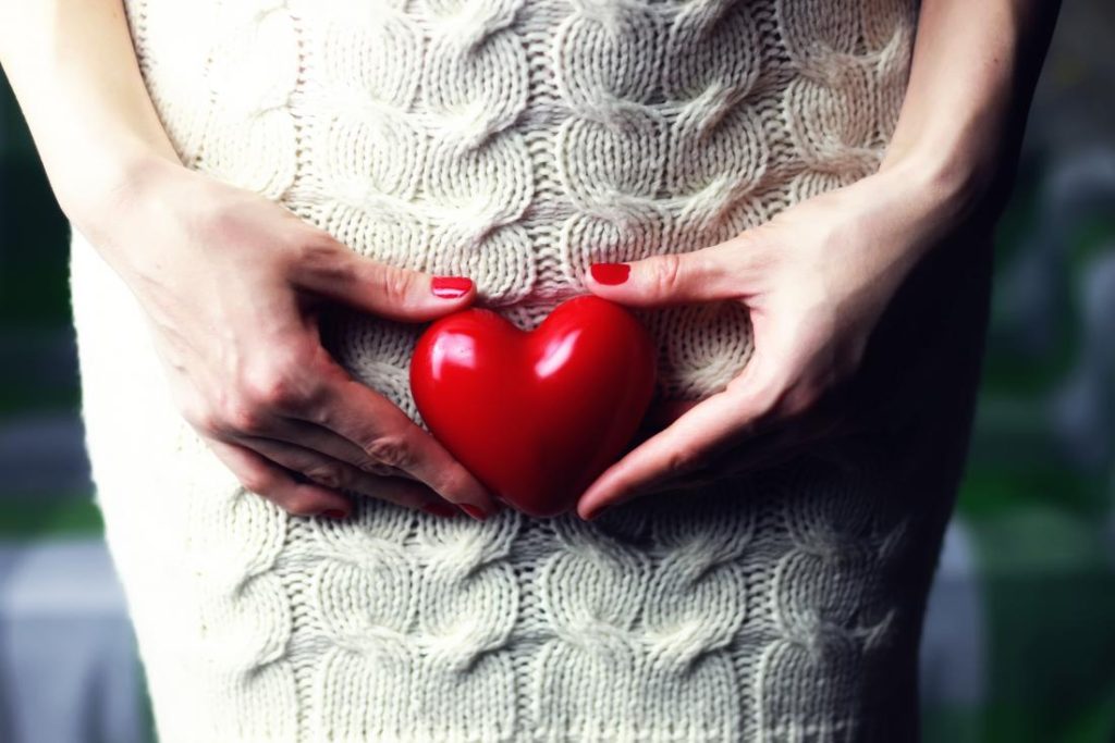 a woman holding a heart