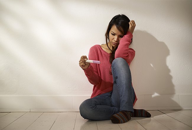 pregnancy test woman frustrated pregnant results