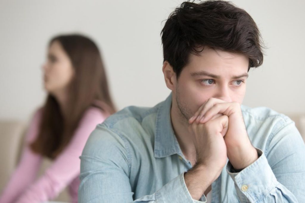 man looking depressed with girlfriend